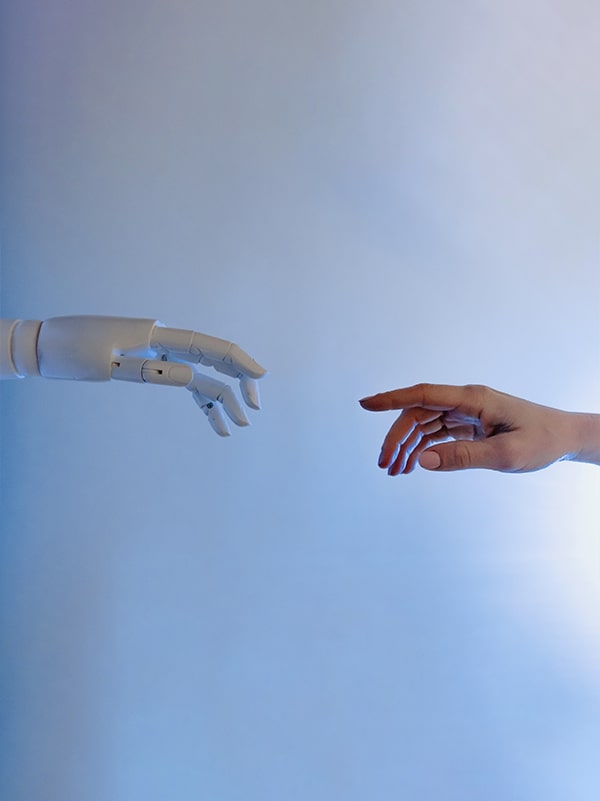 A human hand reaching for a robot's hand