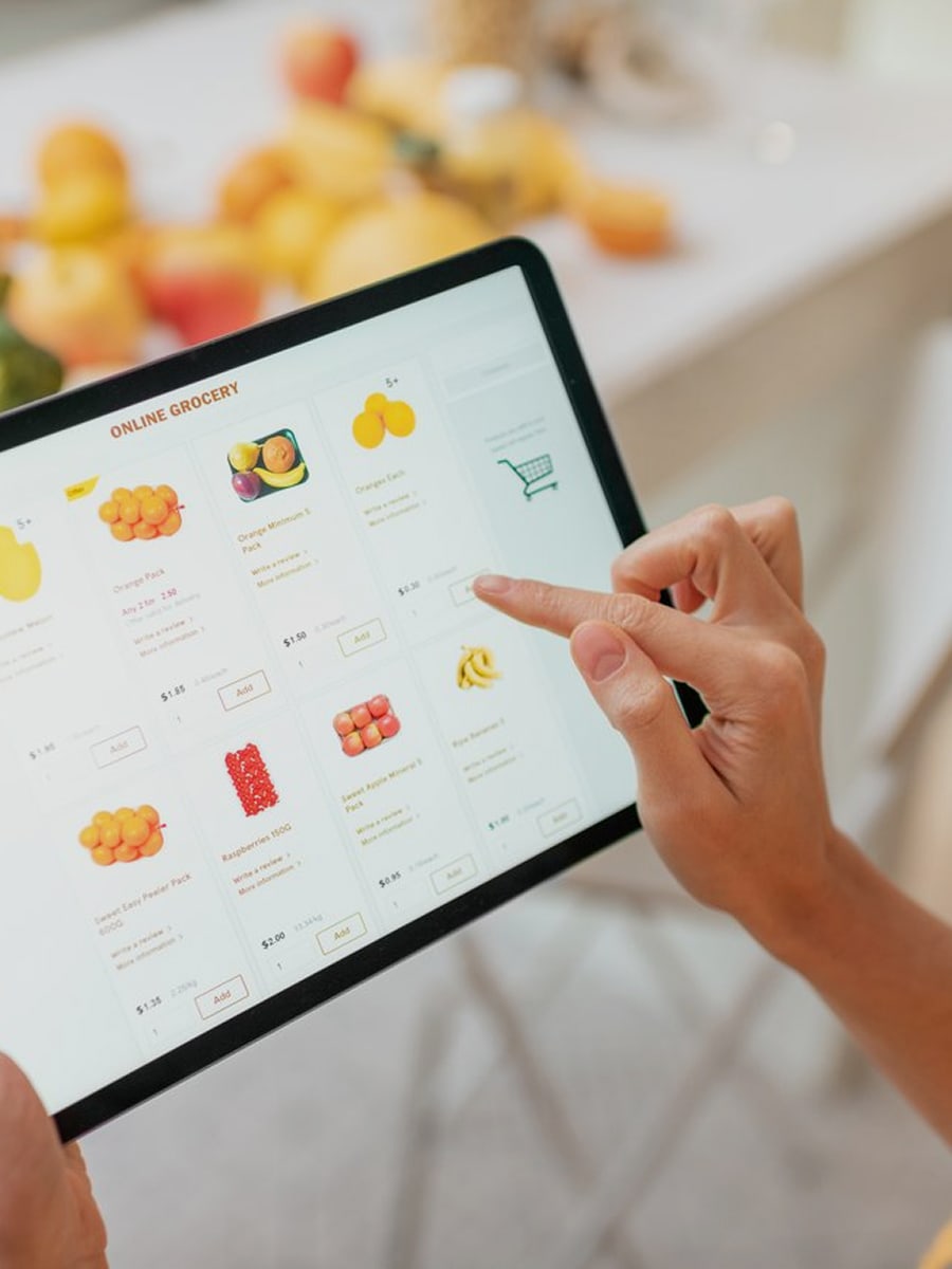 A woman doing grocery shopping on her iPad