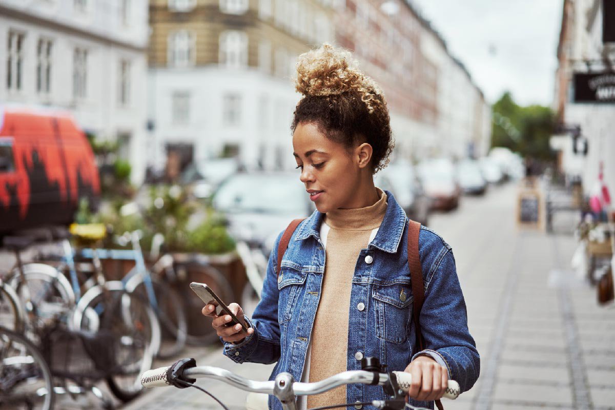 Lady on bike holding mobile phone