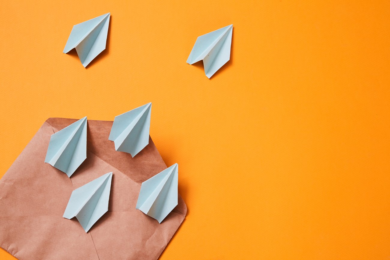 Paper airplanes coming out of an envelope