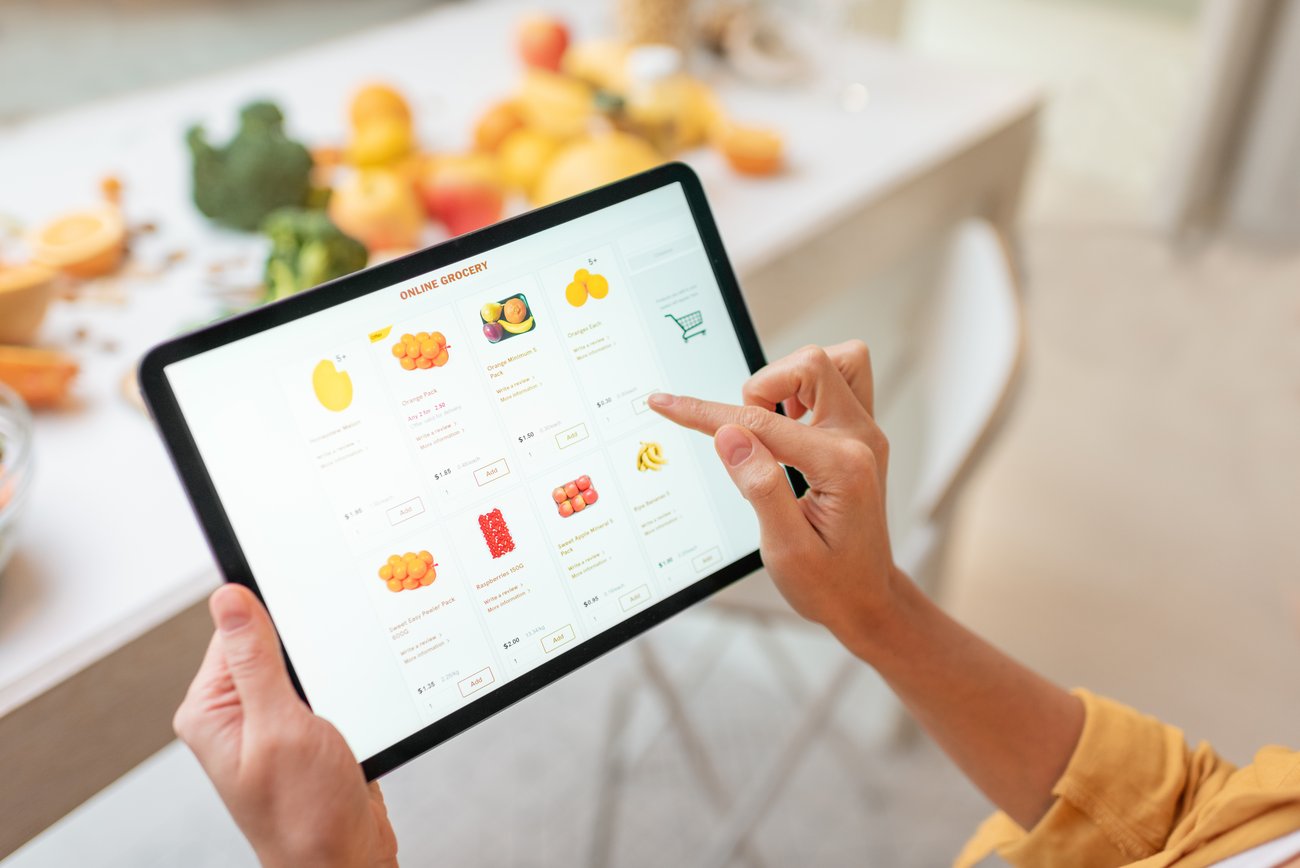 A woman doing grocery shopping on her iPad