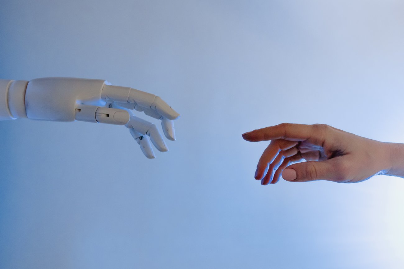 A human hand reaching for a robot's hand