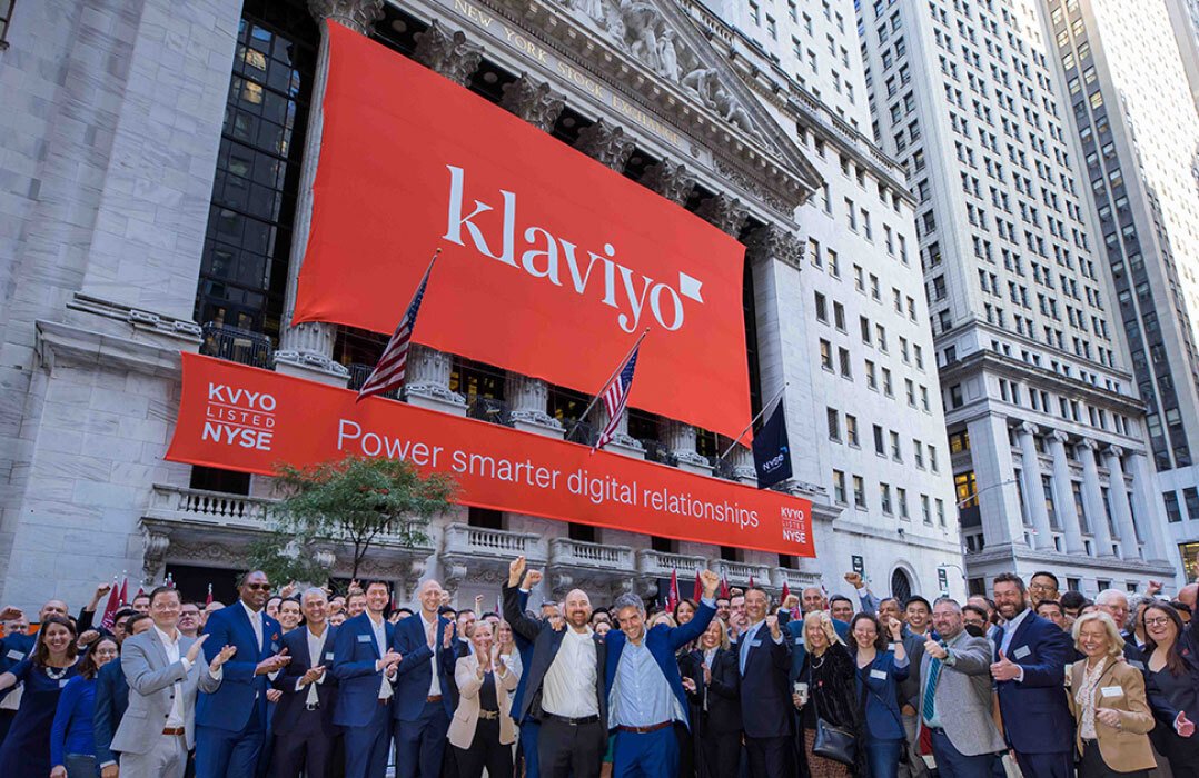 People celebrating under a Klaviyo banner