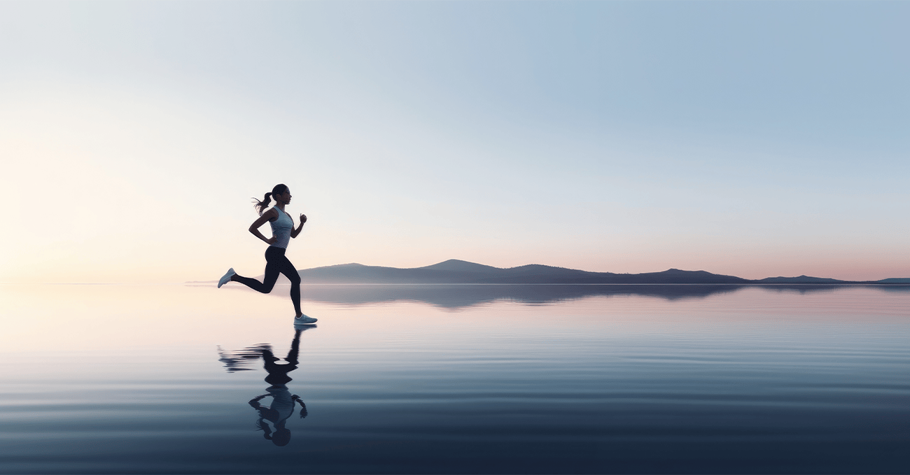 A woman running on the beach during sunset