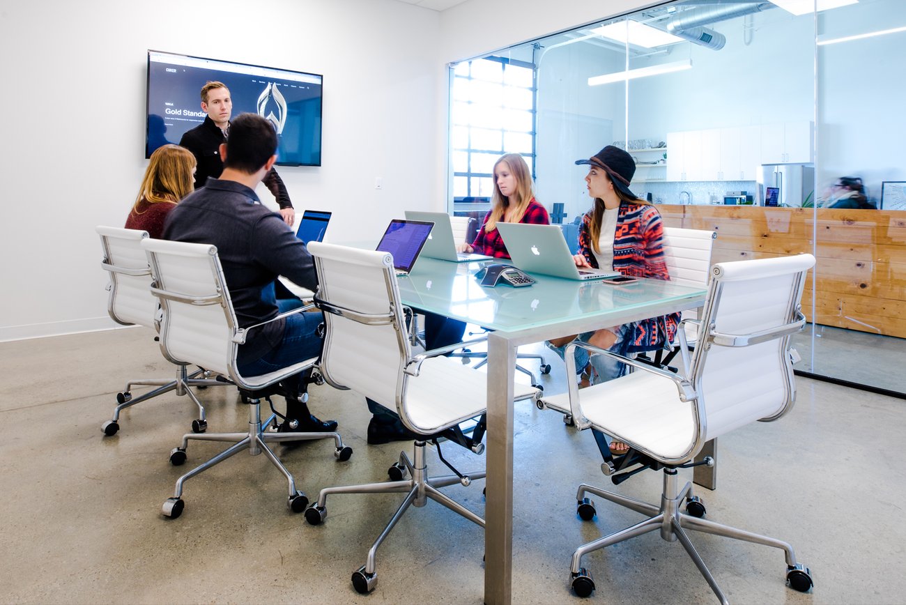 Marketing agency team in a strategy meeting, discussing client work in a modern