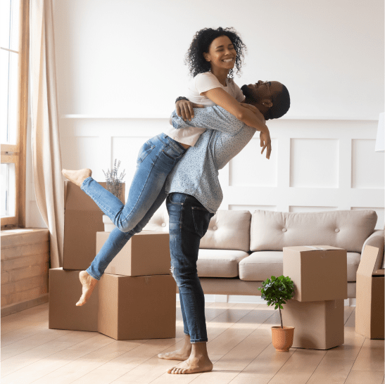 Happy couple hugging in new home made of beautiful building materials