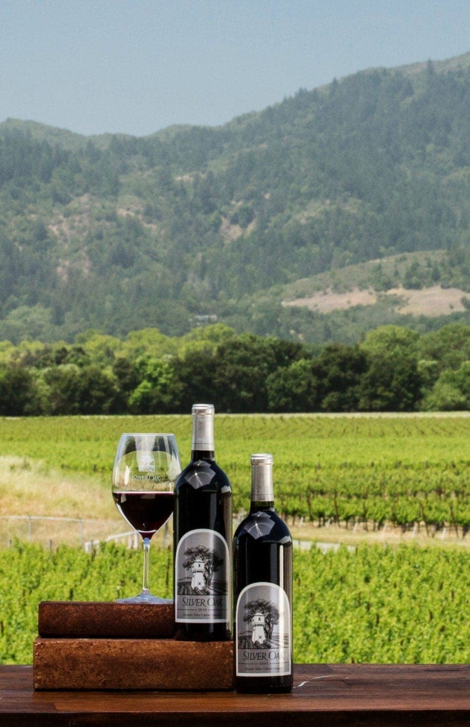 Silver Oak bottles in front of a vineyard